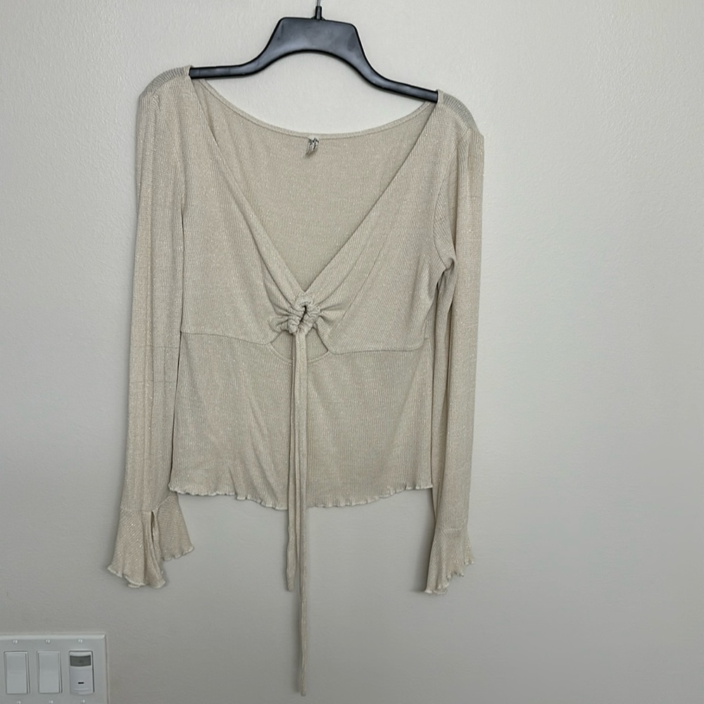 FREE PEOPLE shirt nude with gold shimmer ruffle bottom gently used size Large